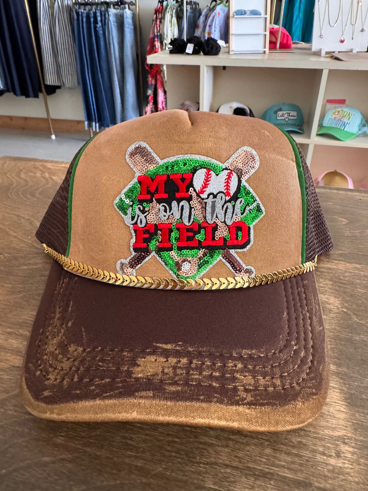My heart is on the field trucker hat